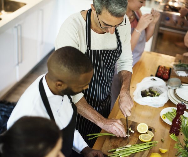 Group of friends cooking in the kitchen